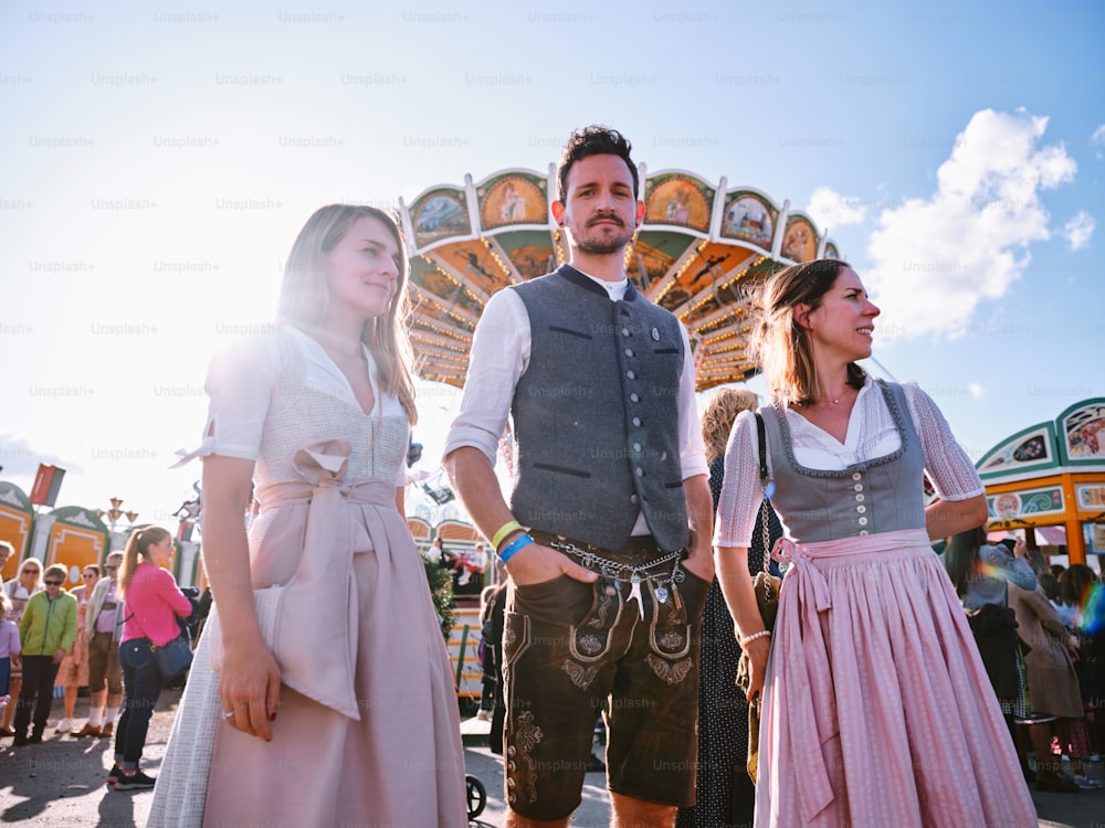 a group of people standing in front of a carnival ride