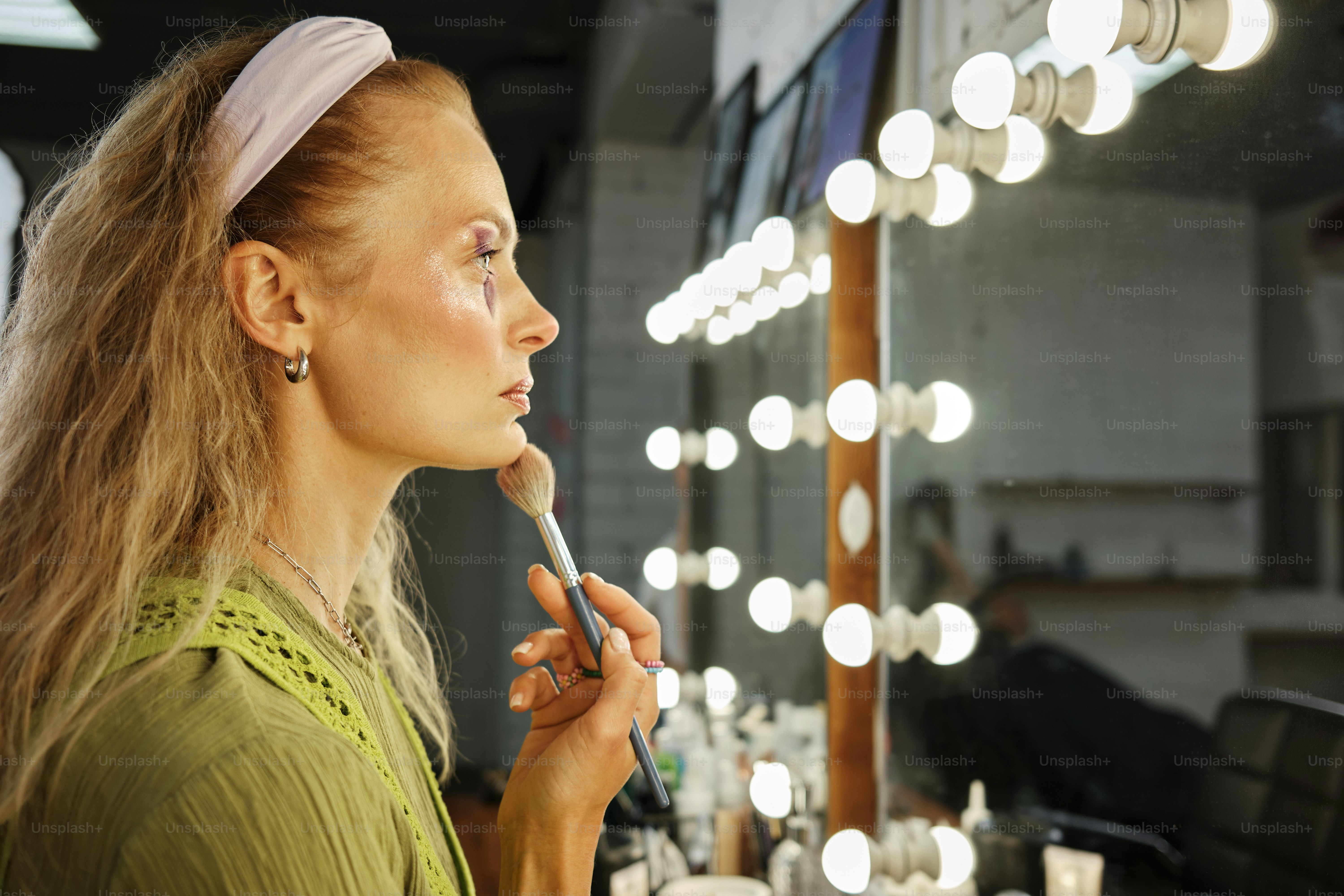 a woman brushes her teeth in front of a mirror