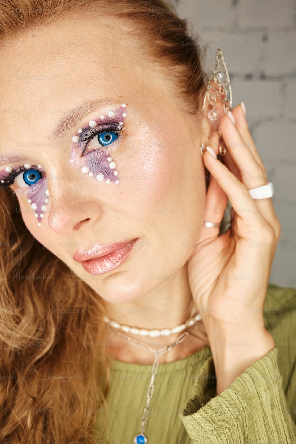 a woman with blue eyes and white stars on her face