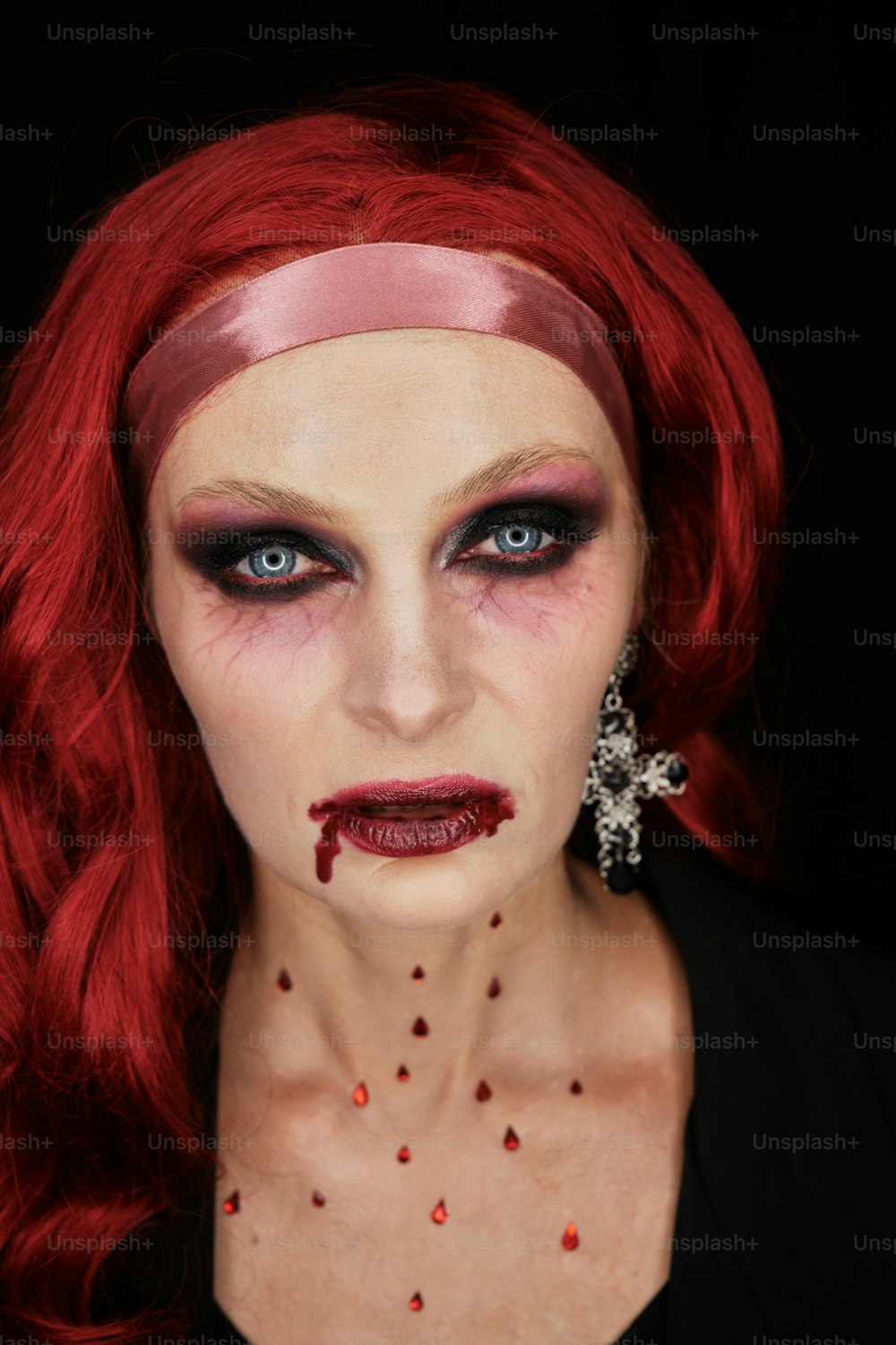 a woman with red hair and makeup is dressed as a zombie