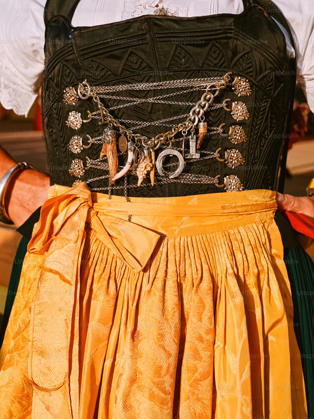 a woman wearing a yellow skirt with a black top