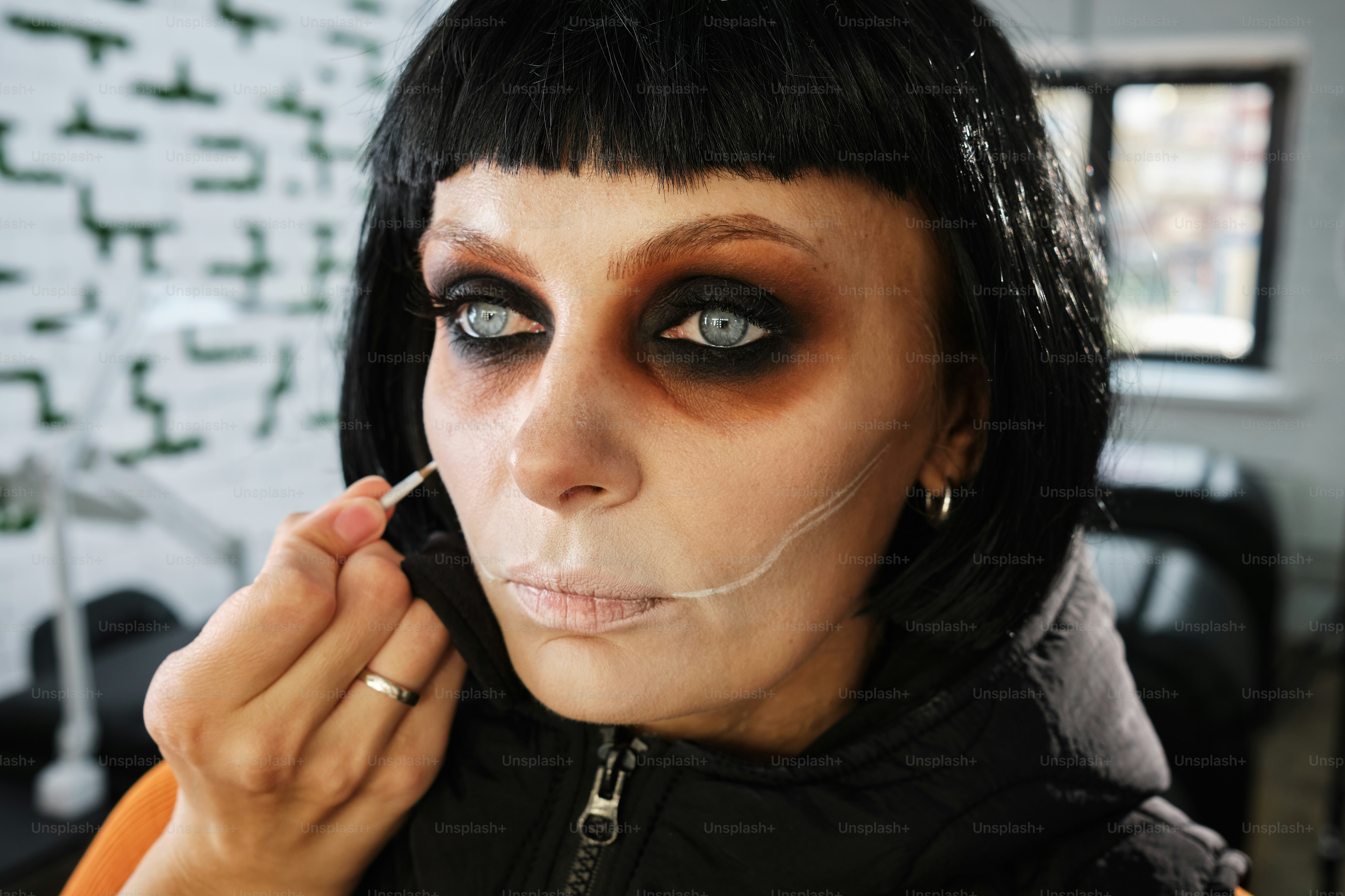 portrait of a woman doing Halloween zombie skull makeup