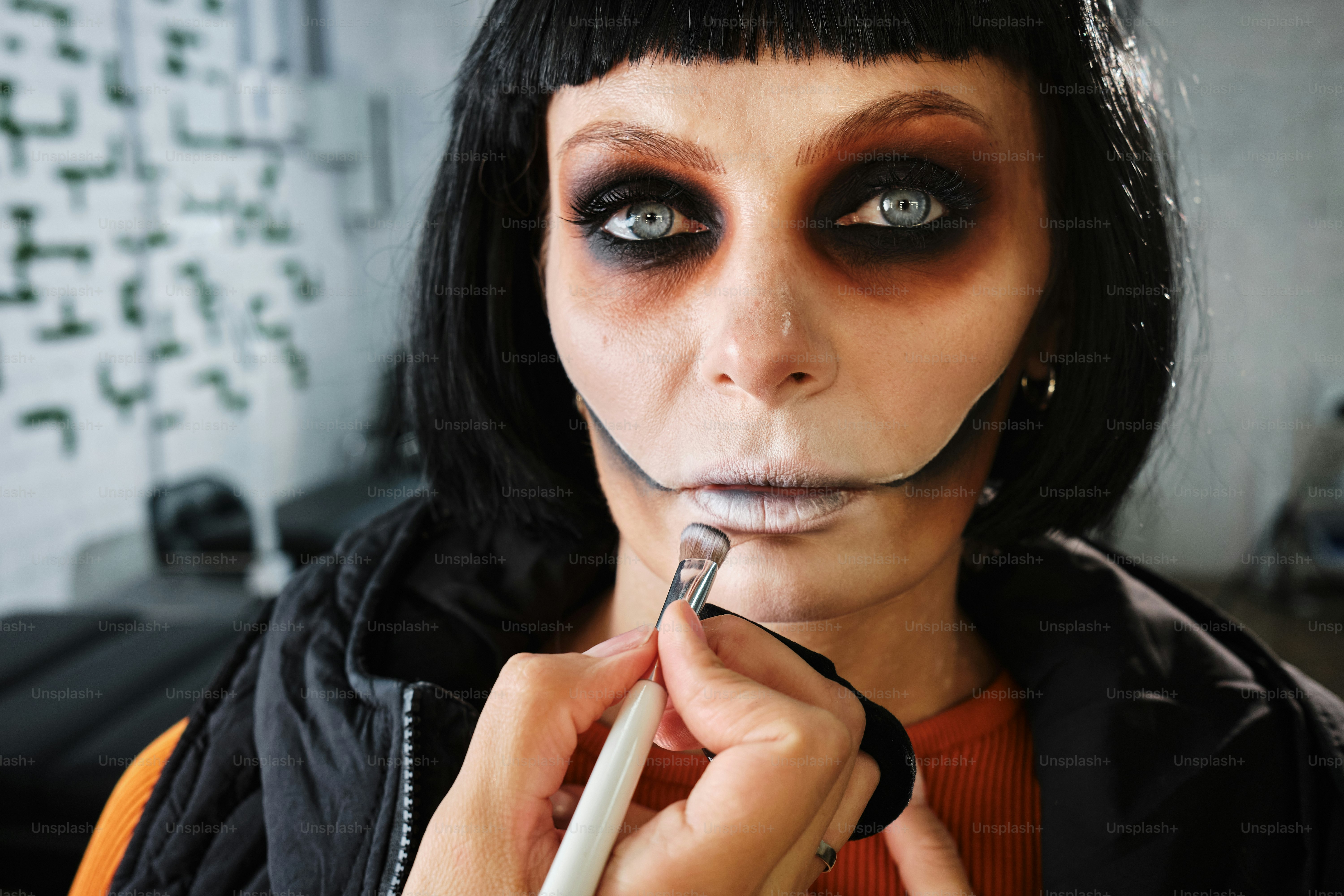 portrait of a woman doing Halloween zombie skull makeup