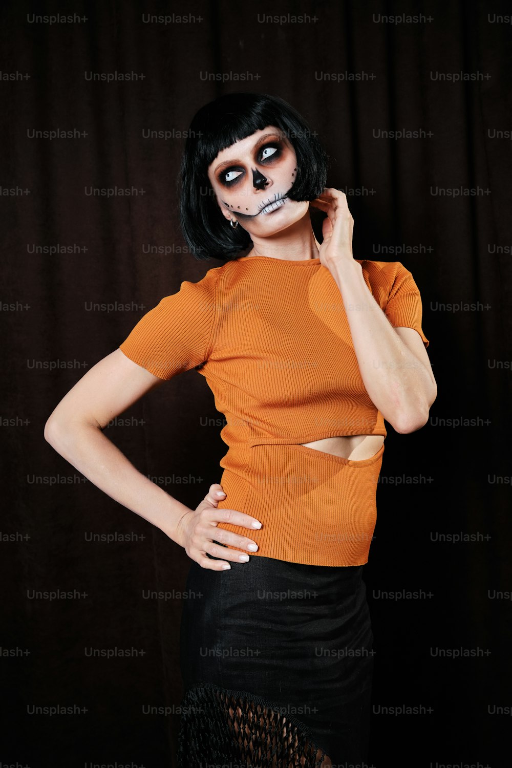 a woman wearing a skeleton makeup and a skirt