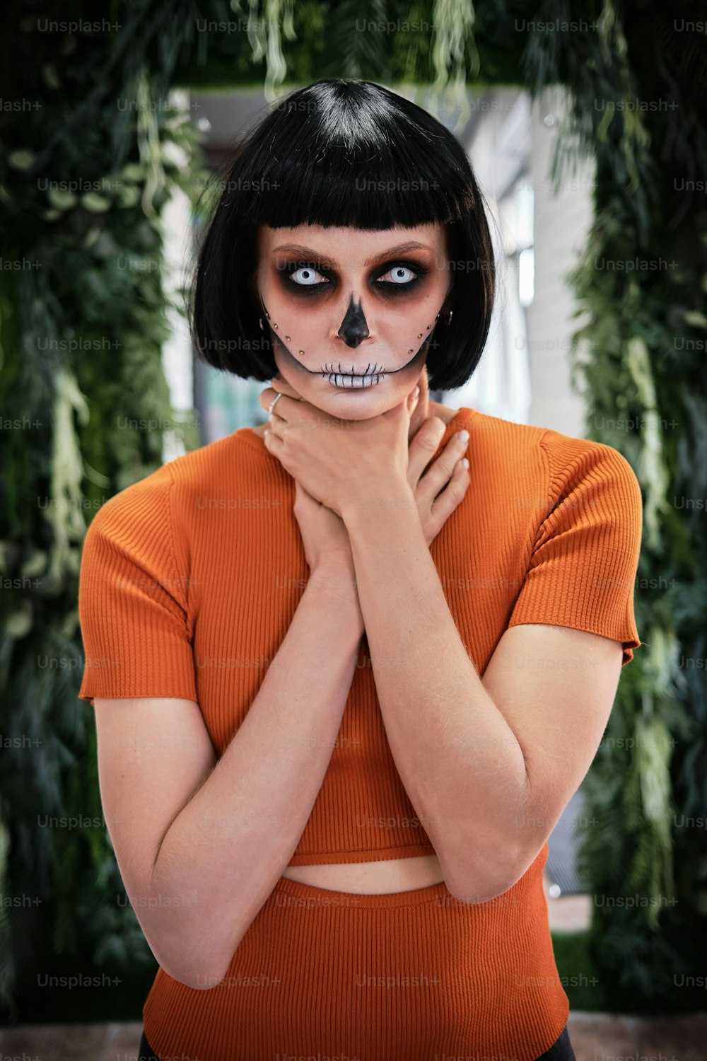 a woman with a skeleton face painted on her face