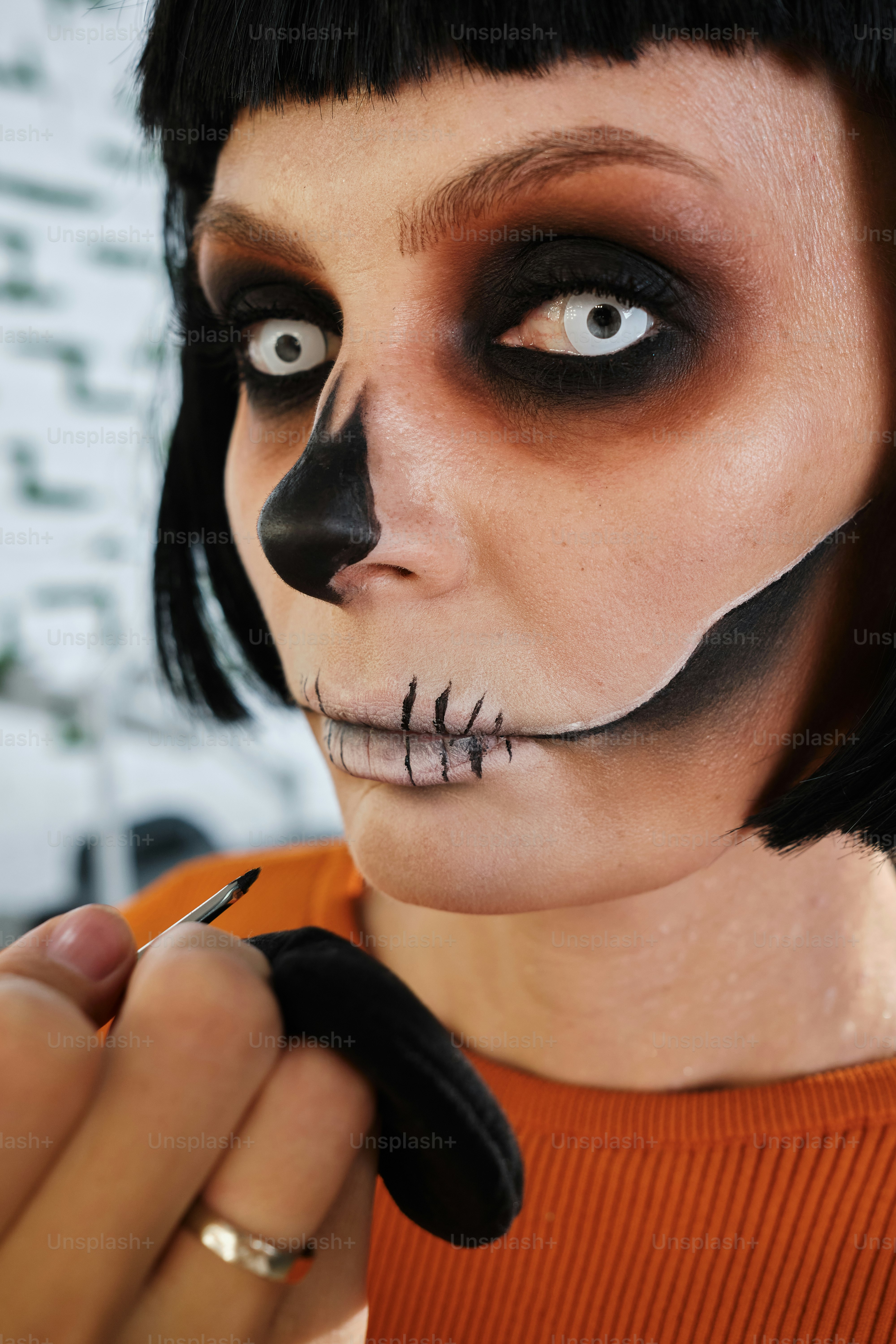 a woman with black makeup and a skeleton make - up