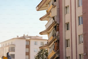 a tall building with lots of windows next to a street