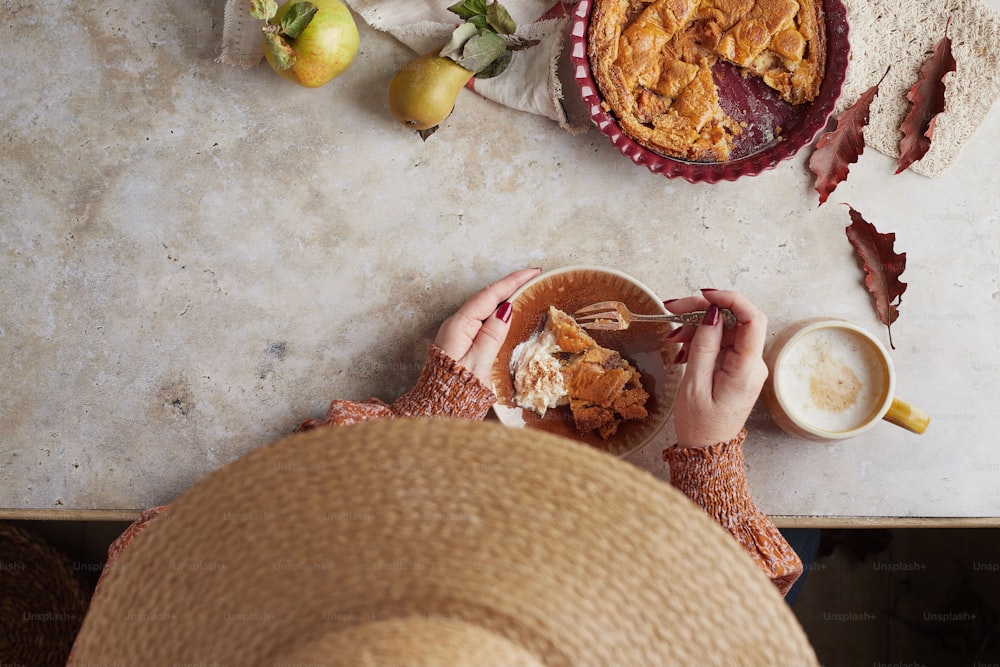 a person sitting at a table eating a piece of pie