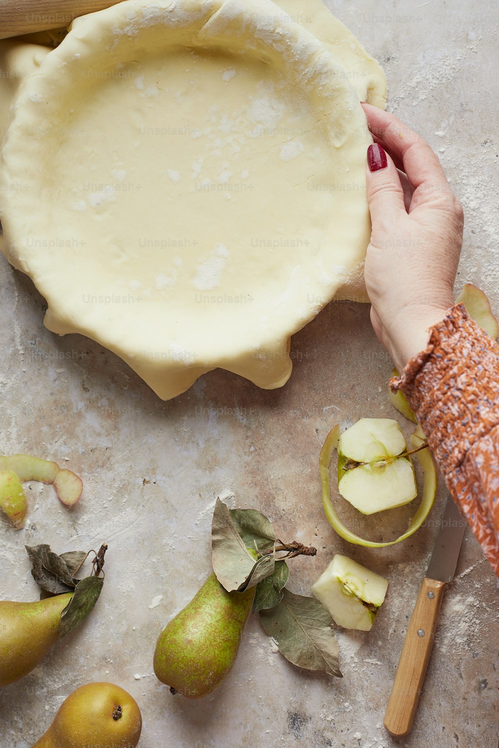 a person holding a pie pan over a table