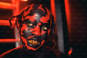 a man with a red and black face paint