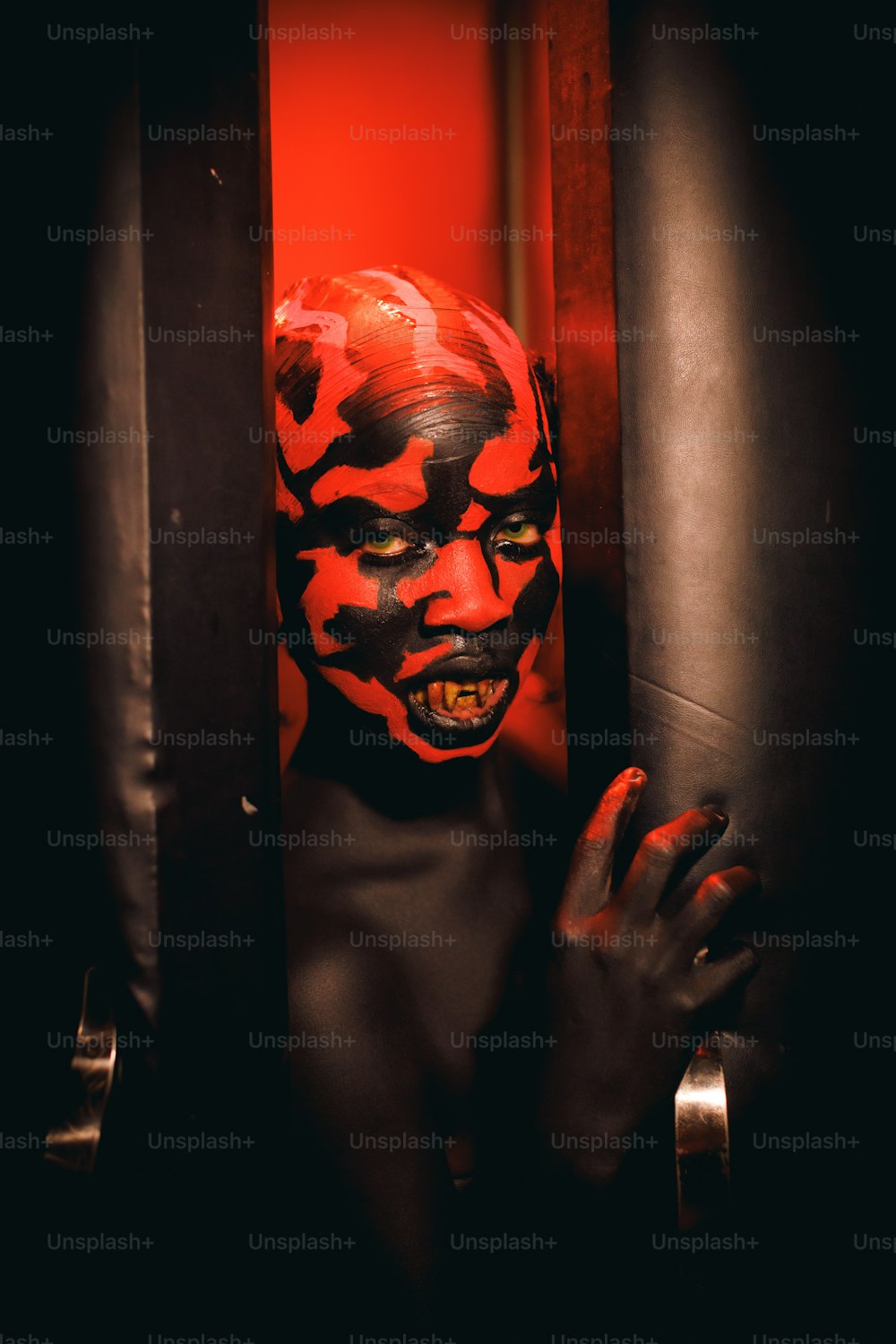 a person with a painted face behind bars