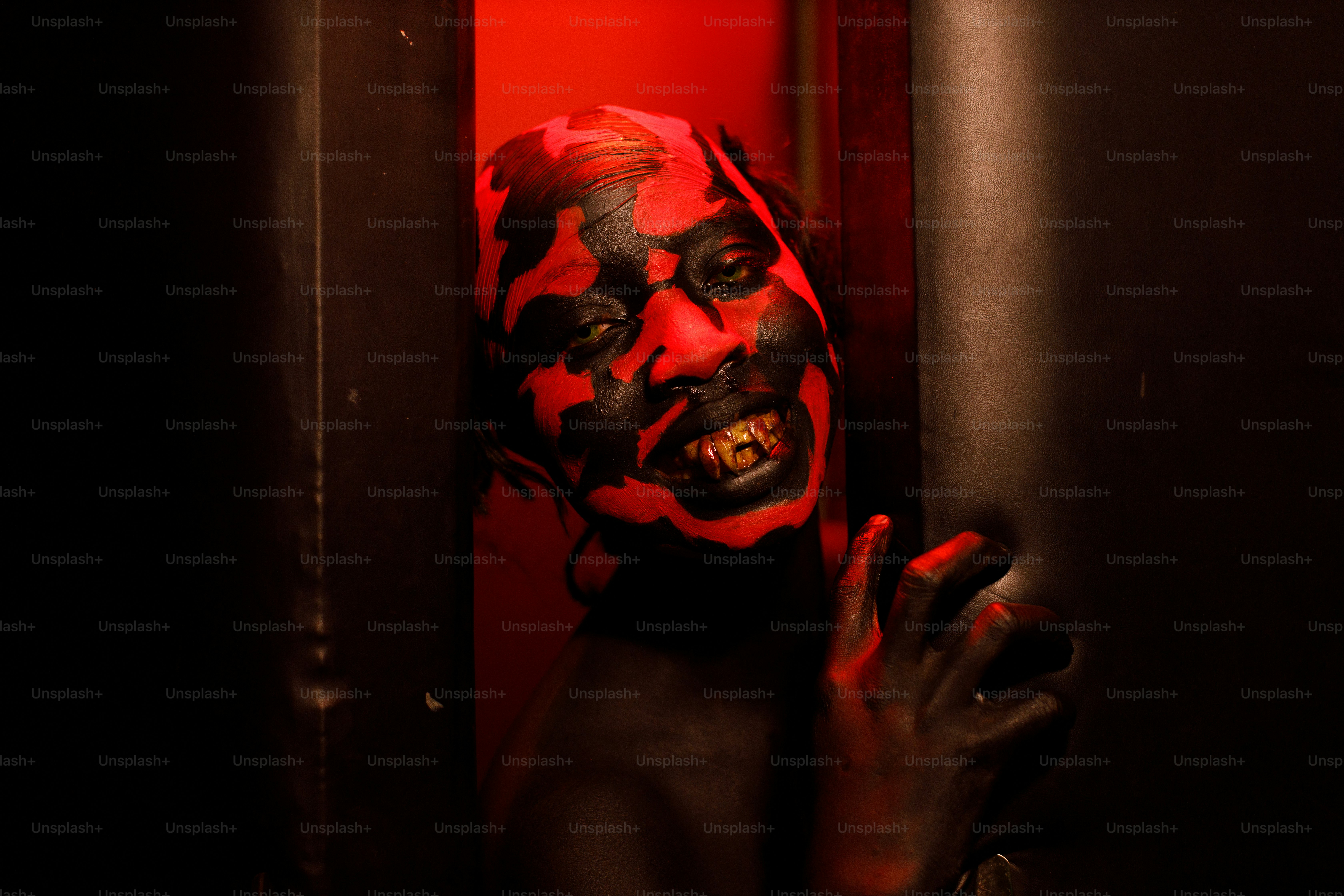 a man with a red and black face painted on