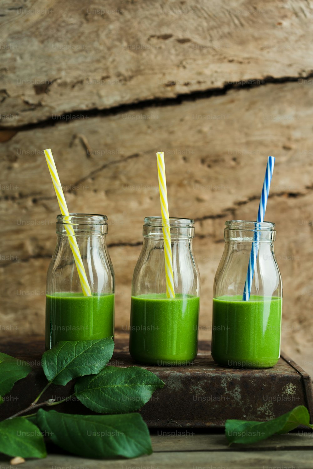 three mason jars filled with green smoothies