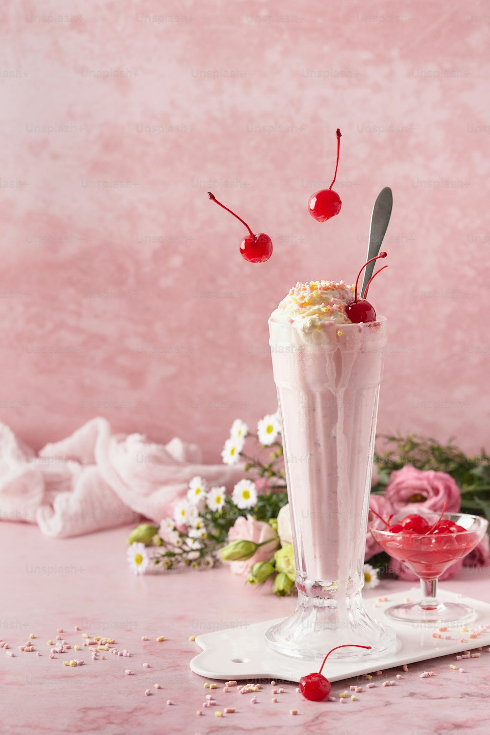 a milkshake topped with whipped cream and cherries