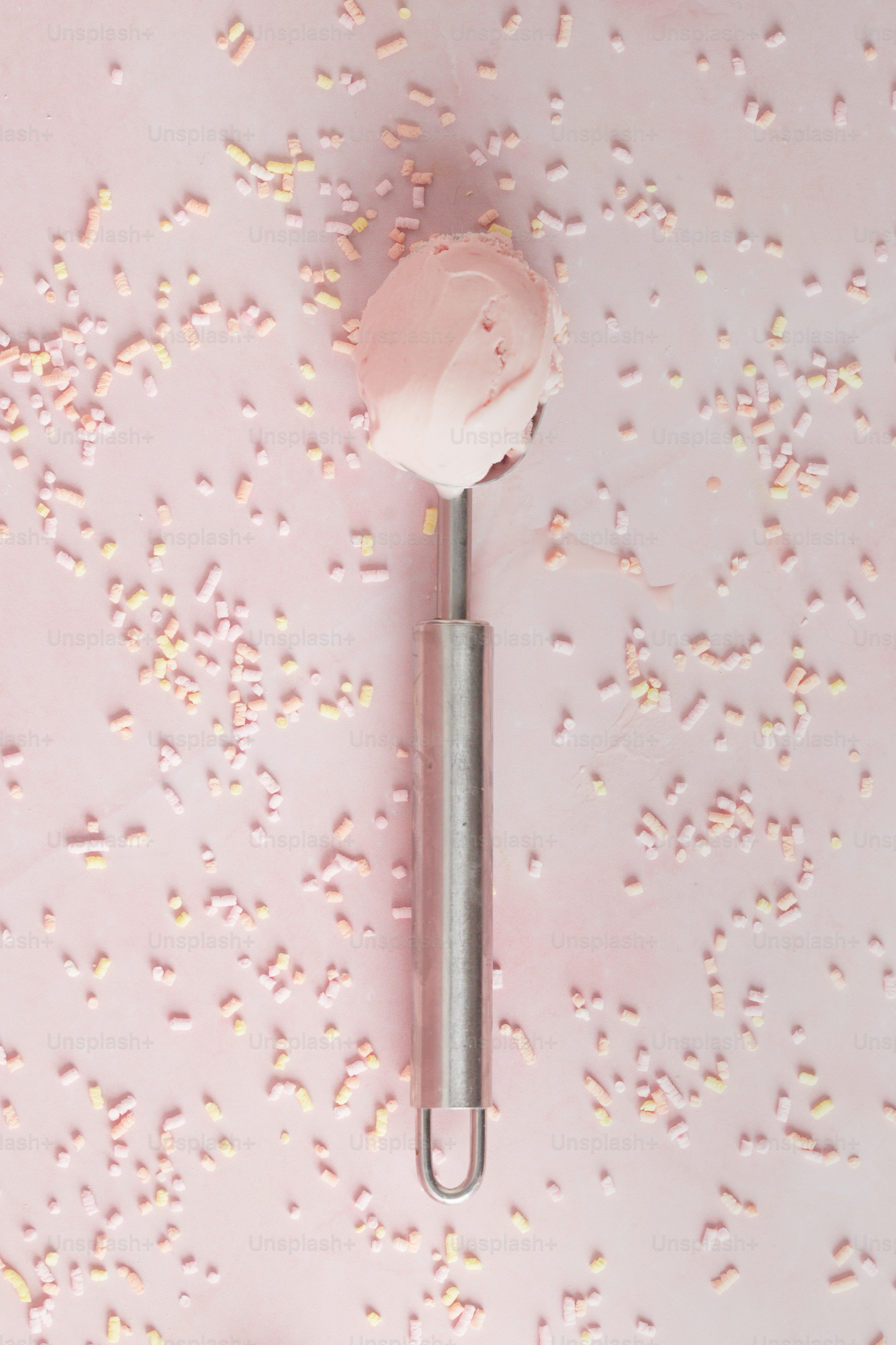 a pink background with a small round object on top of it