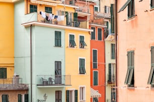 a row of multicolored buildings with balconies