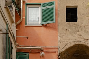 a building with green shutters and a window