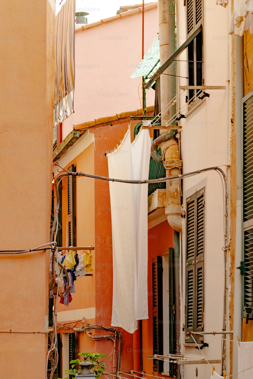 an alleyway with clothes hanging out to dry