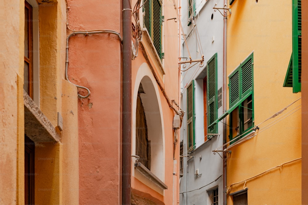 a narrow alleyway with a clock on the side