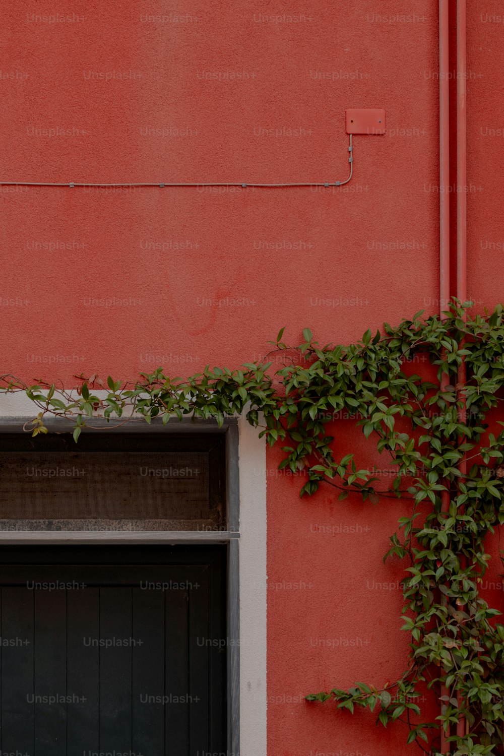 a red building with a black door and window