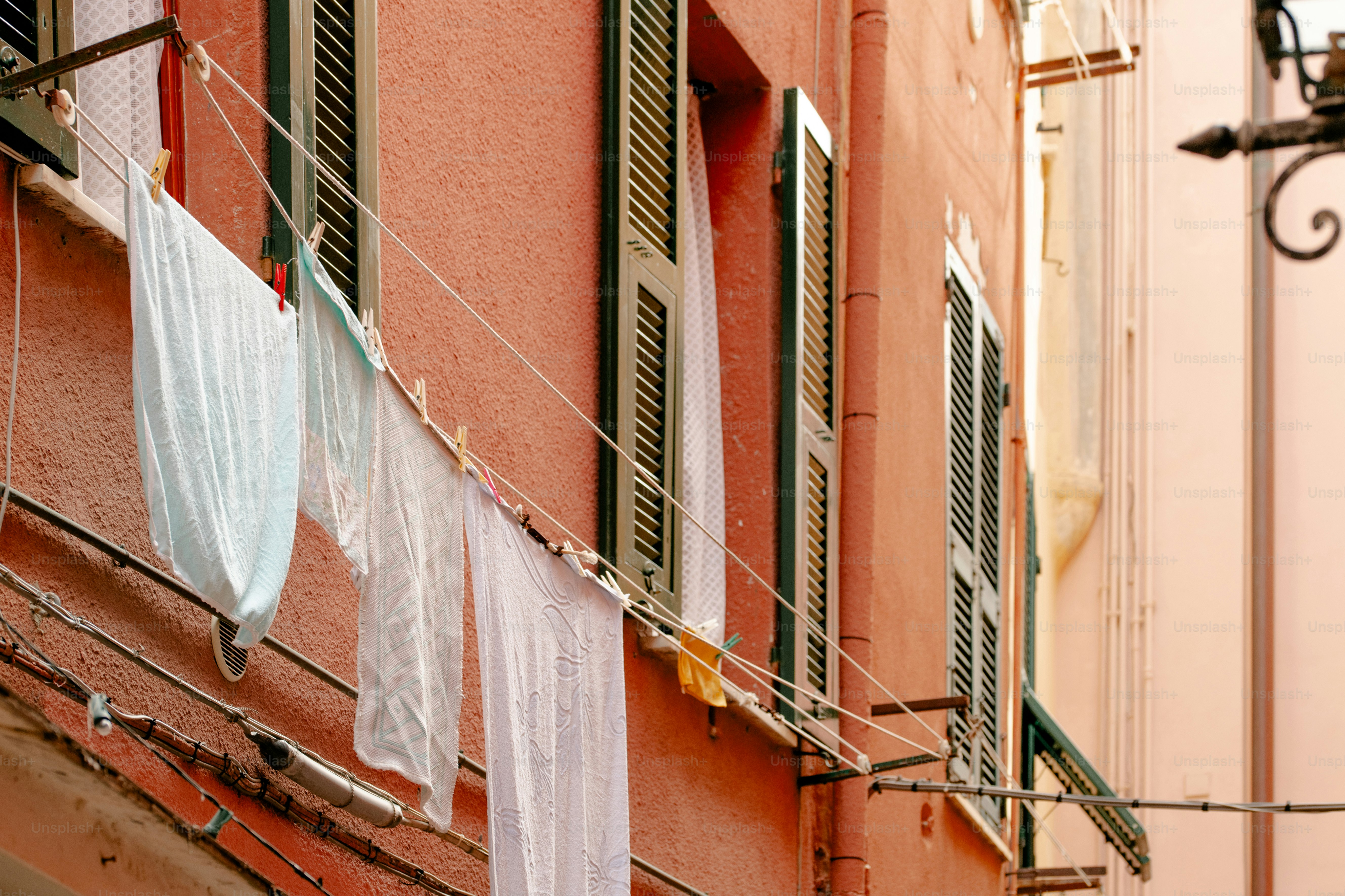 clothes hanging on a clothes line outside of a building