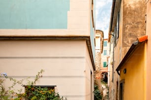 a narrow alley way with a clock on the wall