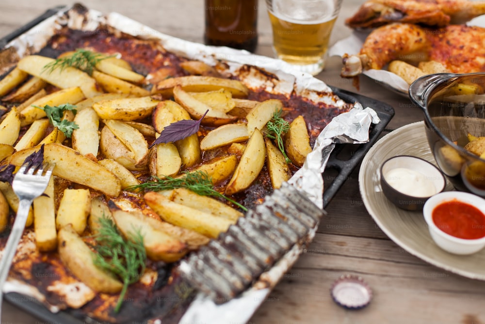 a tray of food on a table next to a glass of beer