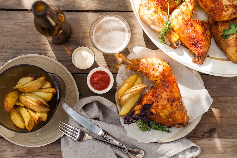 a table topped with plates of food and a bowl of fries