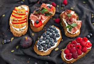 a variety of breads with fruits and vegetables on them