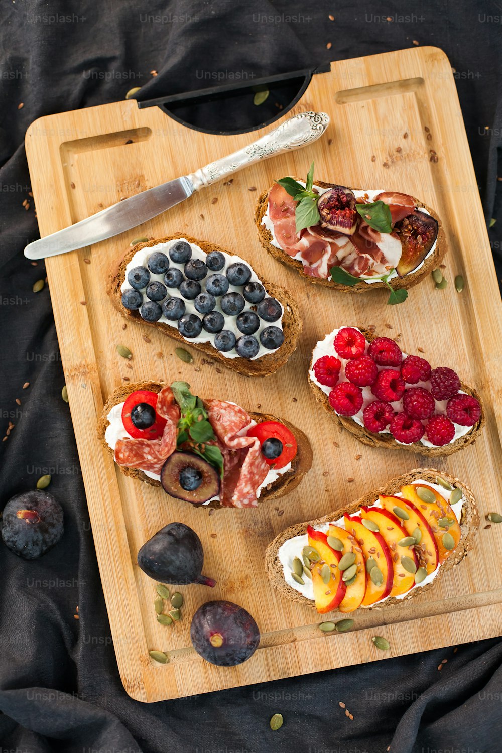 a wooden cutting board topped with different types of food