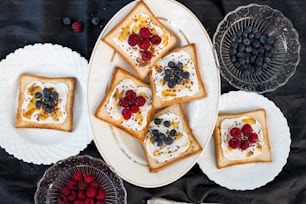 a white plate topped with toast covered in fruit