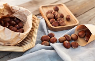 a couple of baskets filled with nuts on top of a wooden table