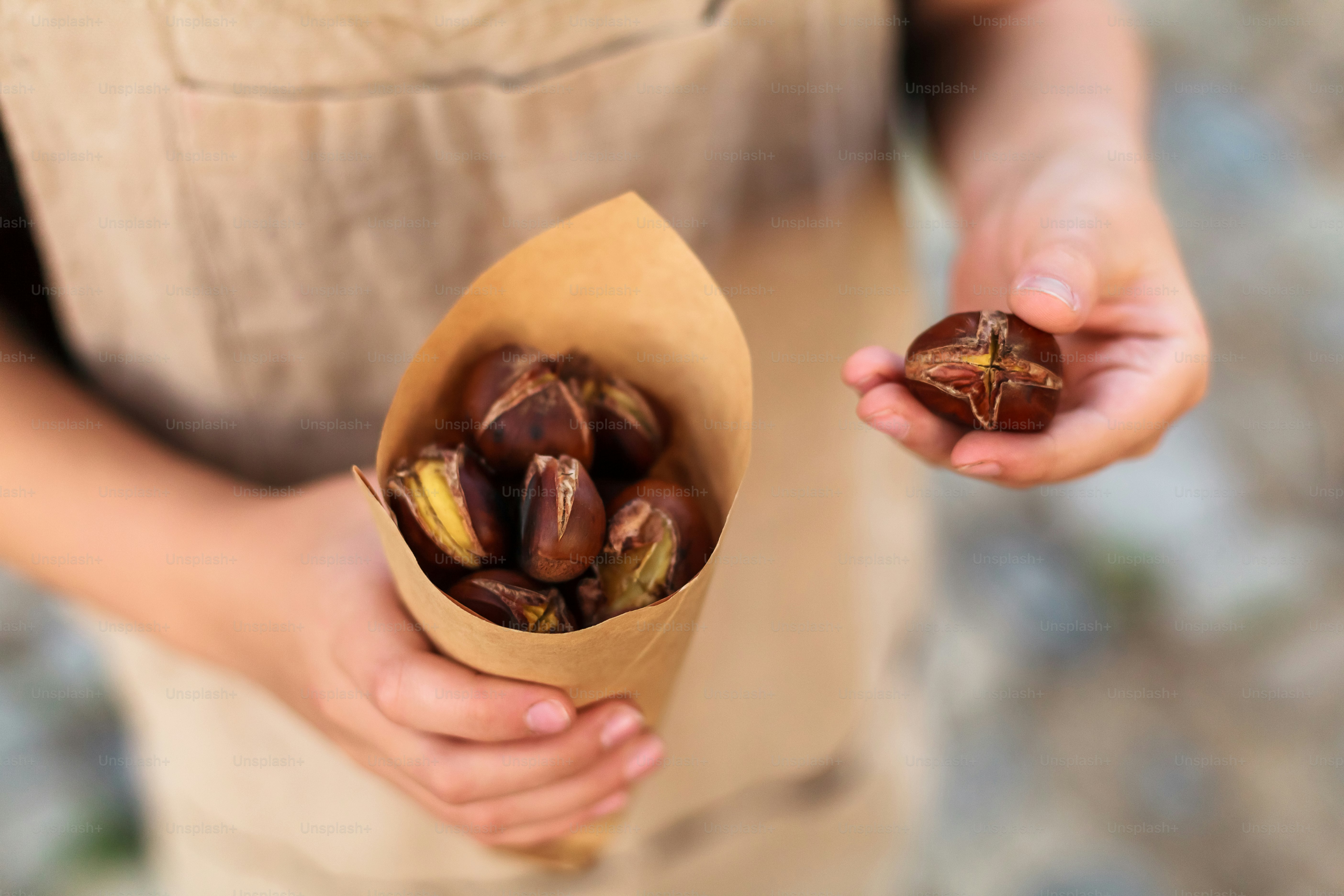a person holding a paper bag filled with nuts