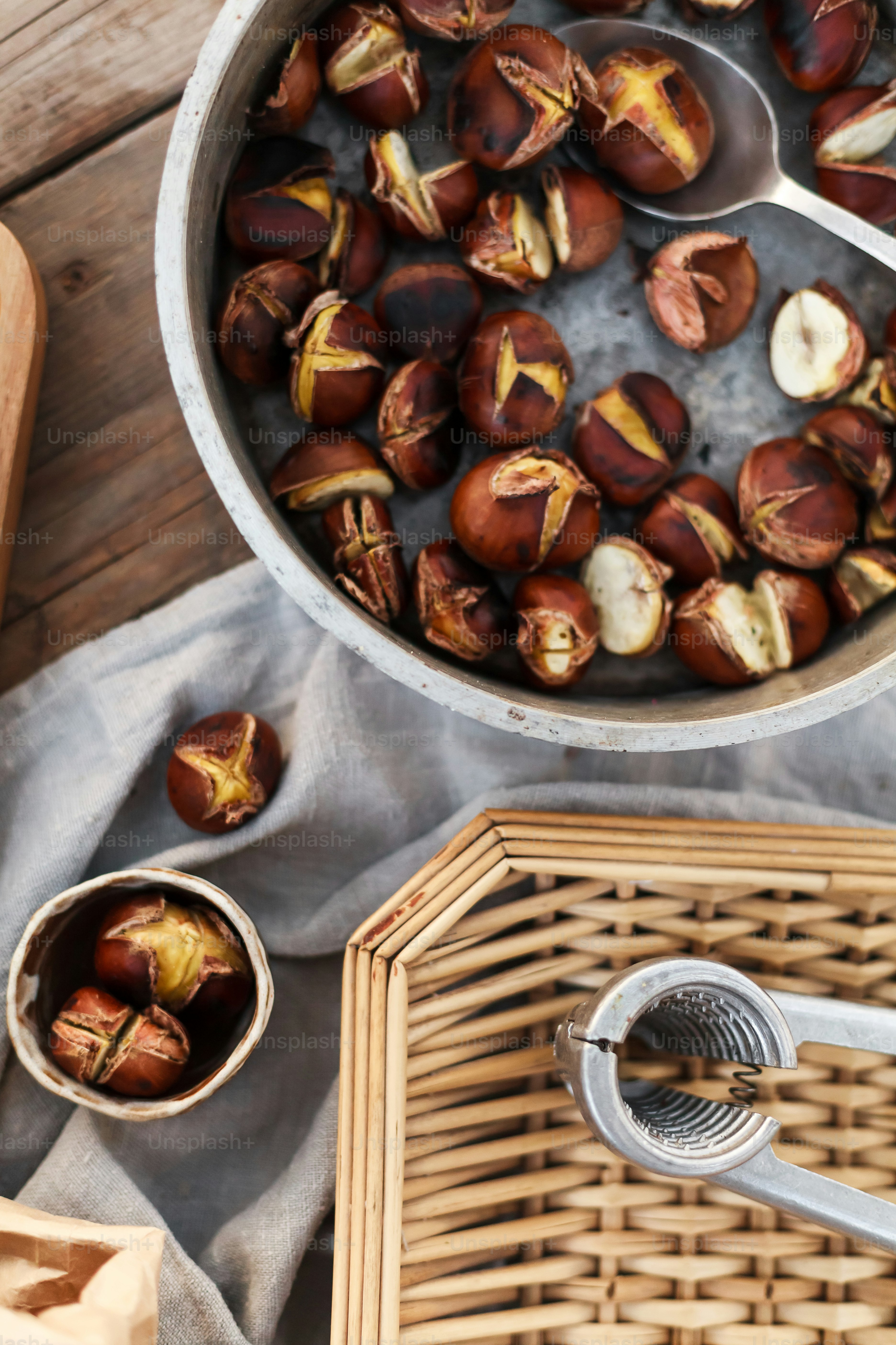a bowl of nuts next to a basket of nuts