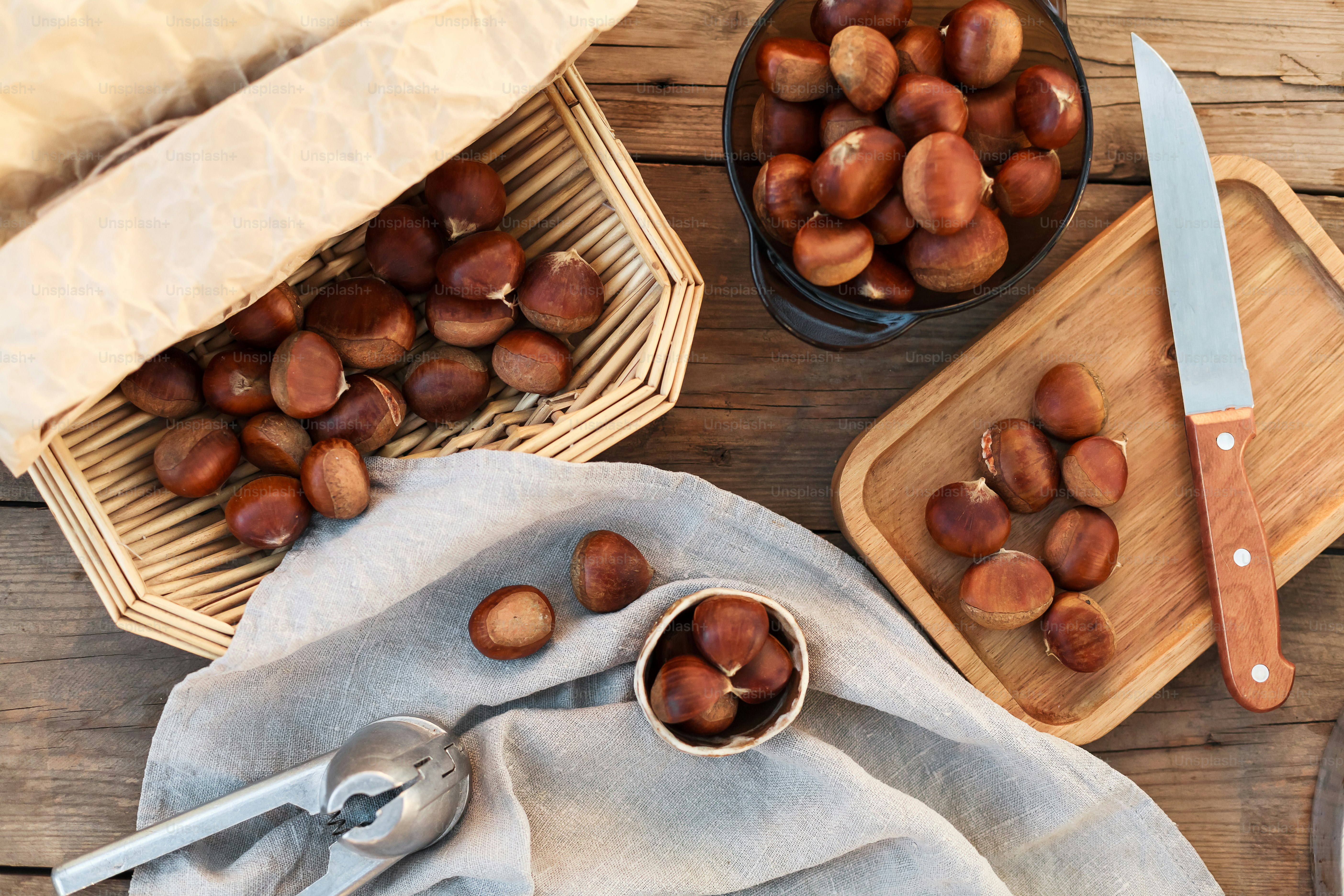 a wooden table topped with bowls filled with nuts