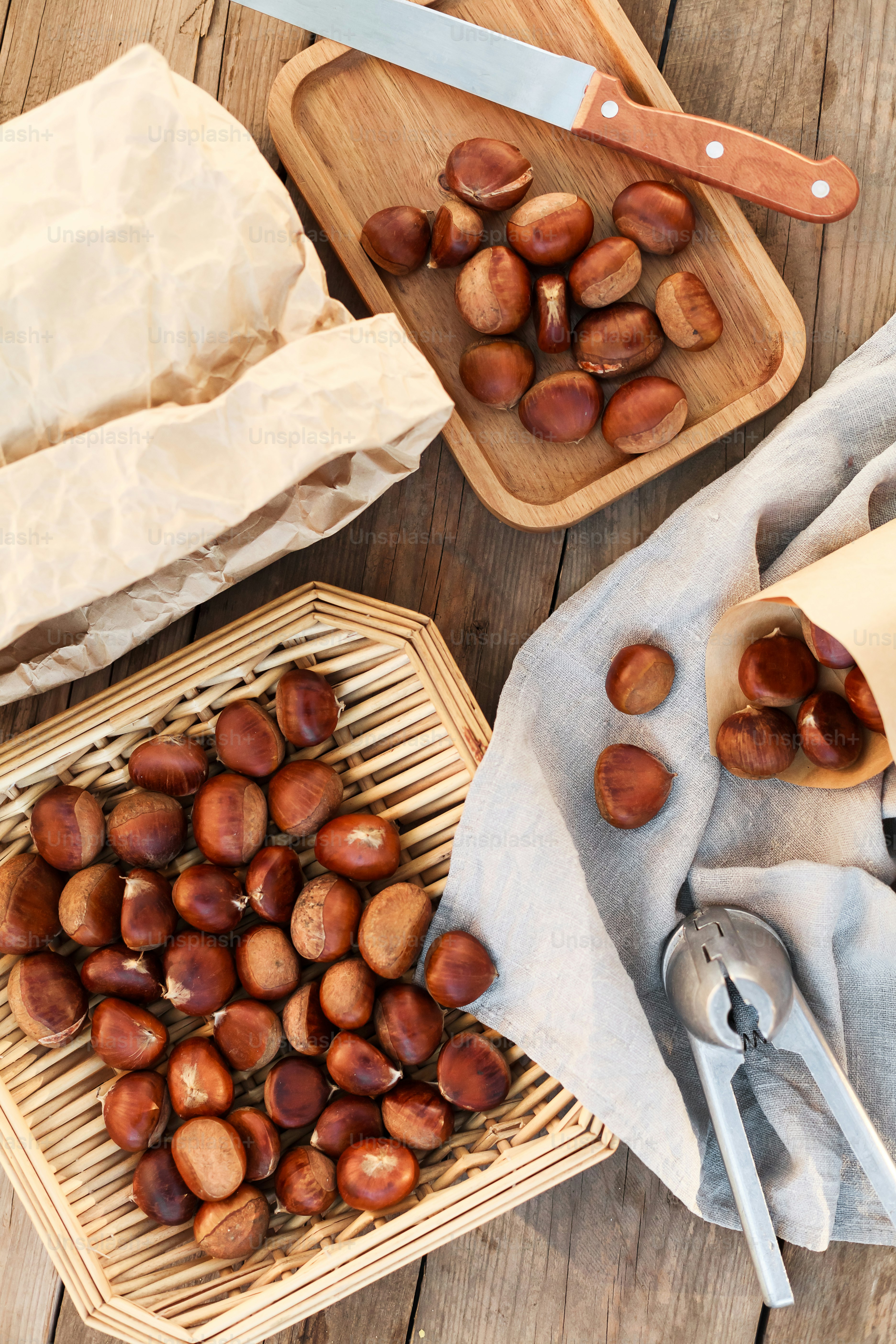 a wooden table topped with trays of nuts
