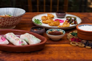 a wooden table topped with plates of food