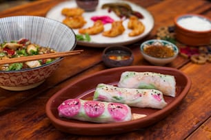 a wooden table topped with plates of food