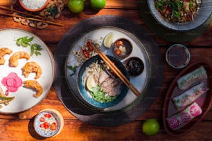 a table topped with plates and bowls of food