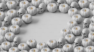 a group of white pumpkins with skulls on them