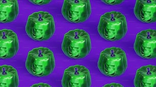 a pattern of green faces on a purple background