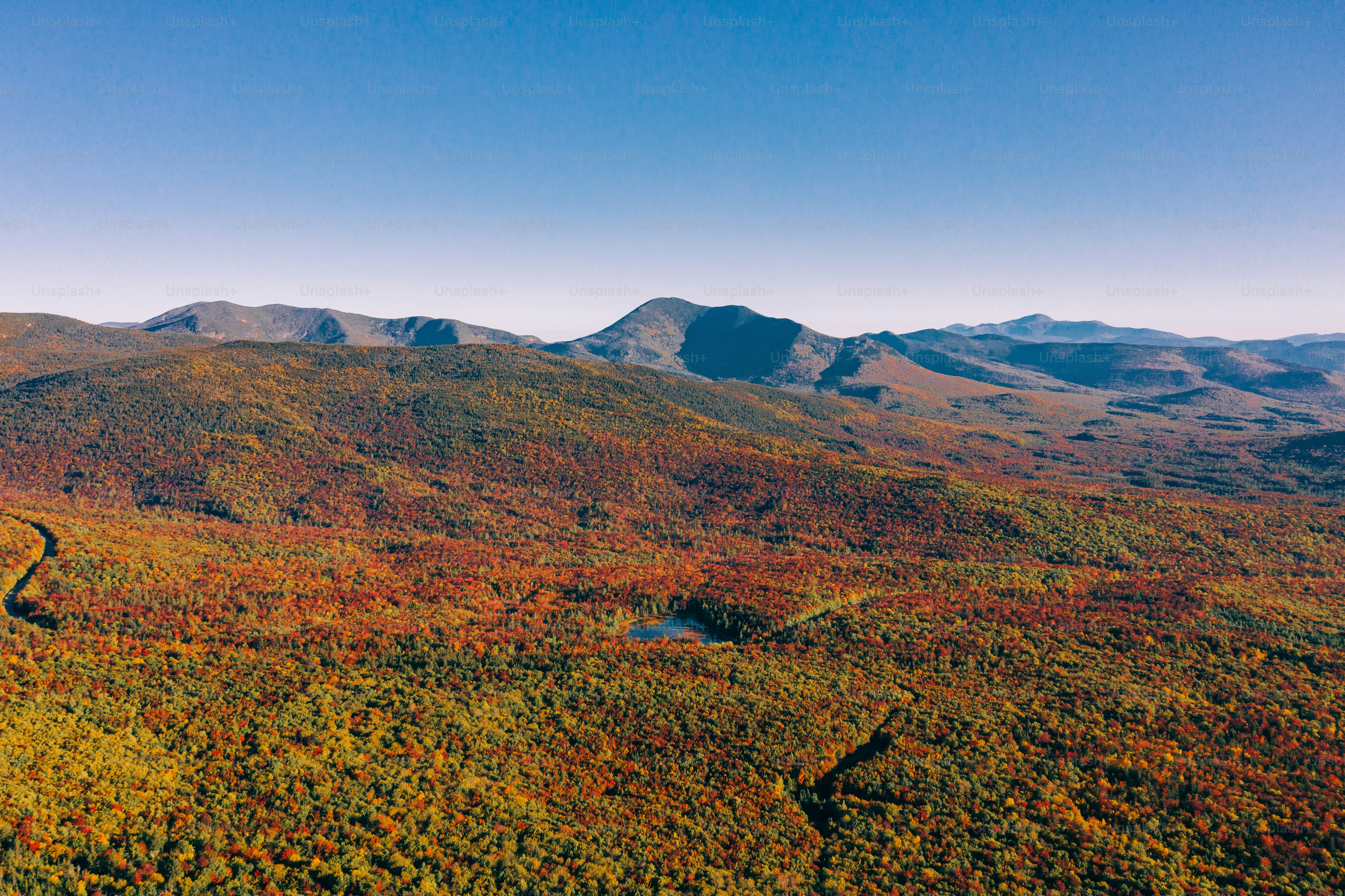 an aerial view of a mountain range in autumn