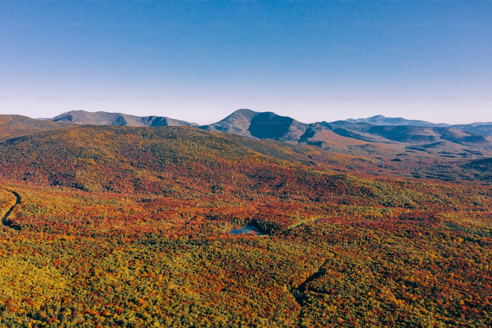 an aerial view of a mountain range in autumn