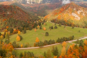 an aerial view of a road winding through a valley