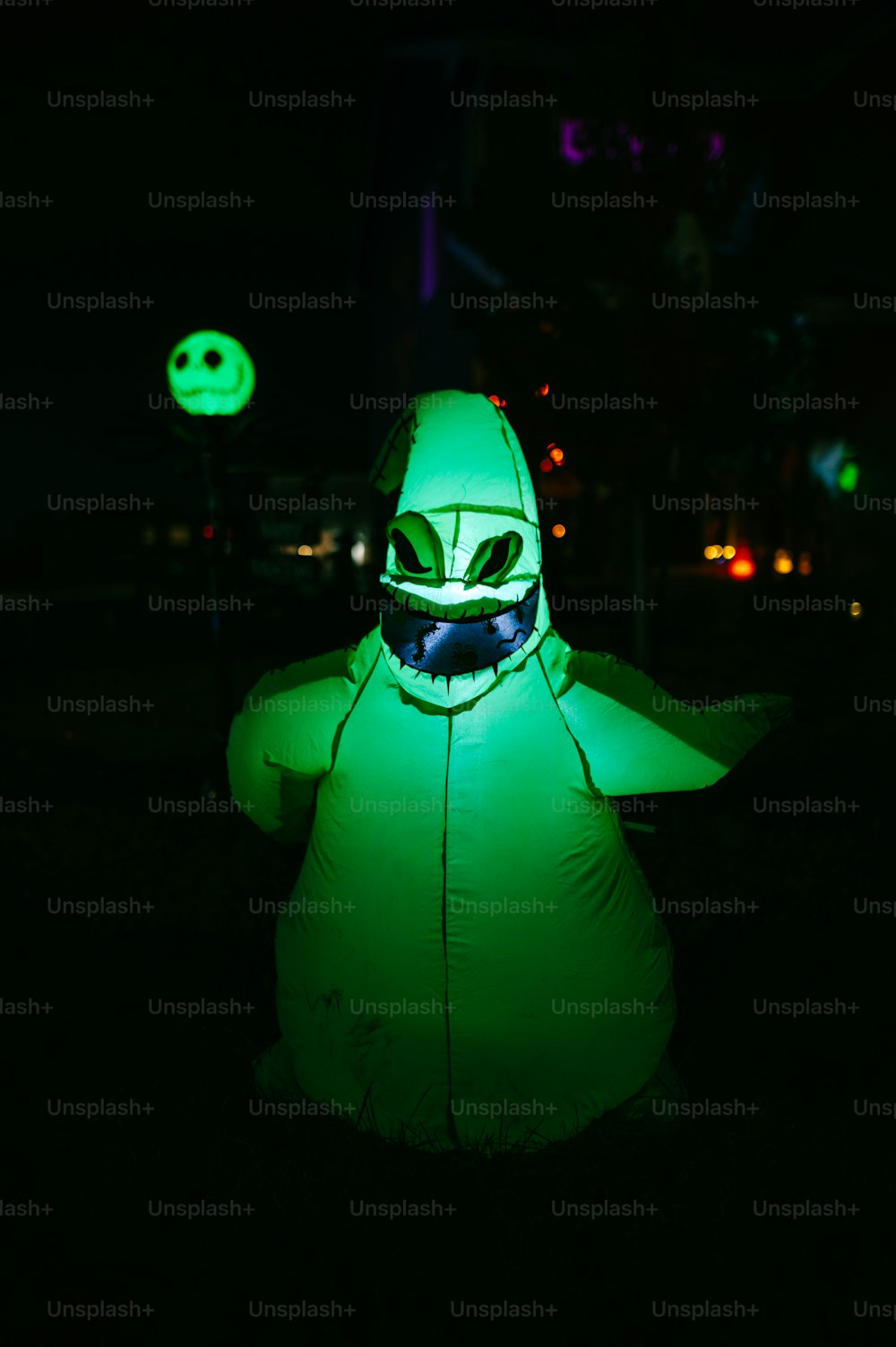 a person in a green costume with a mask on
