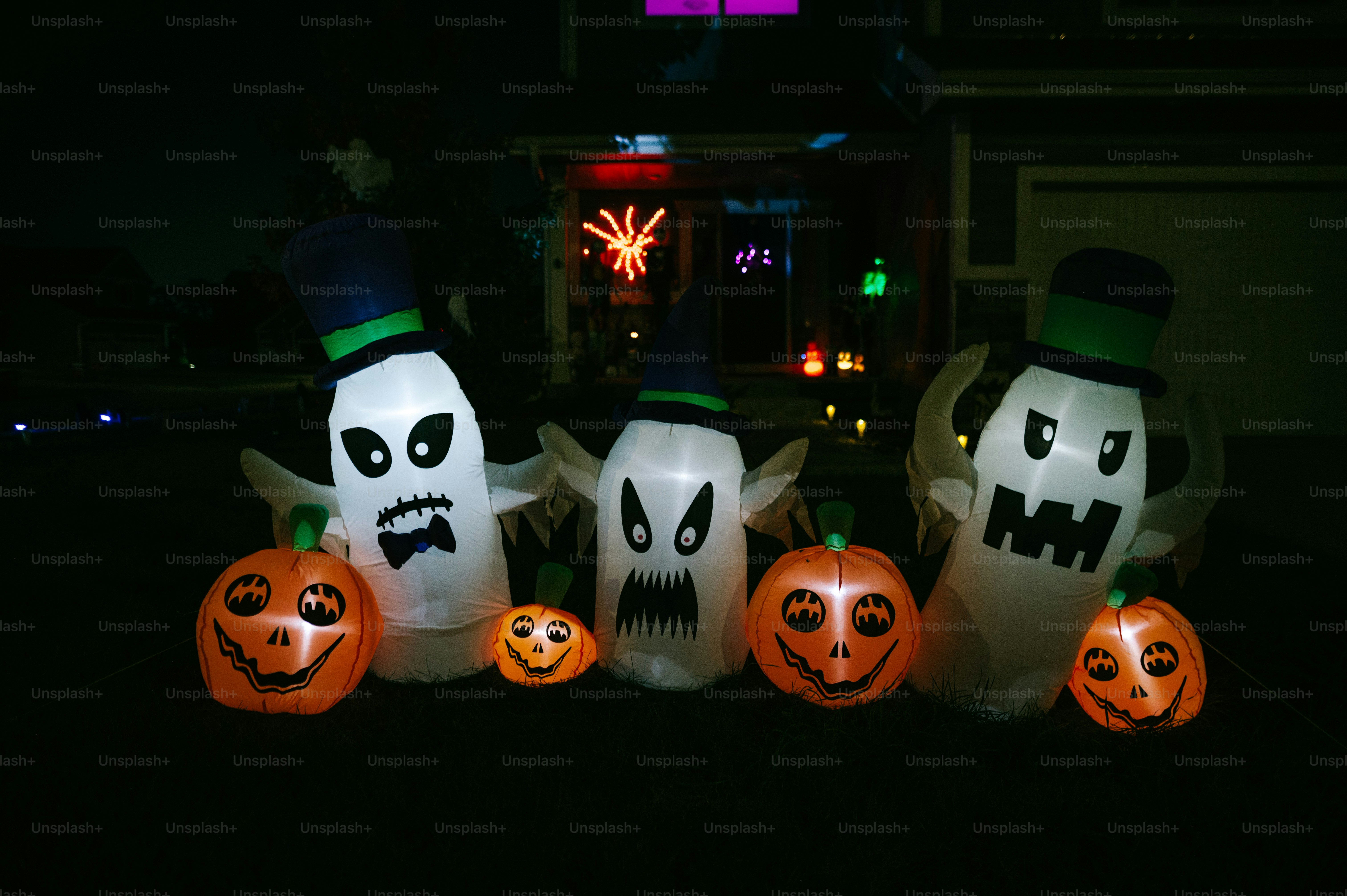 a group of halloween pumpkins sitting in front of a house