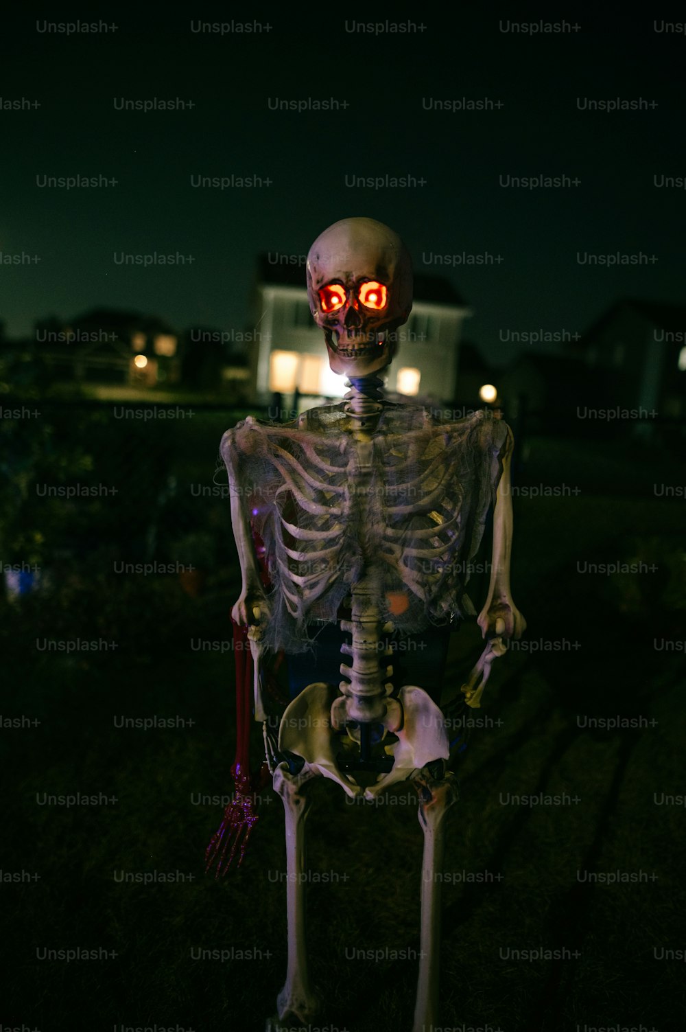 a skeleton with glowing eyes standing in the dark