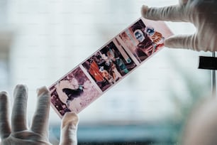 a person holding up a card with pictures on it