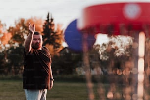 a man is throwing a frisbee in a field