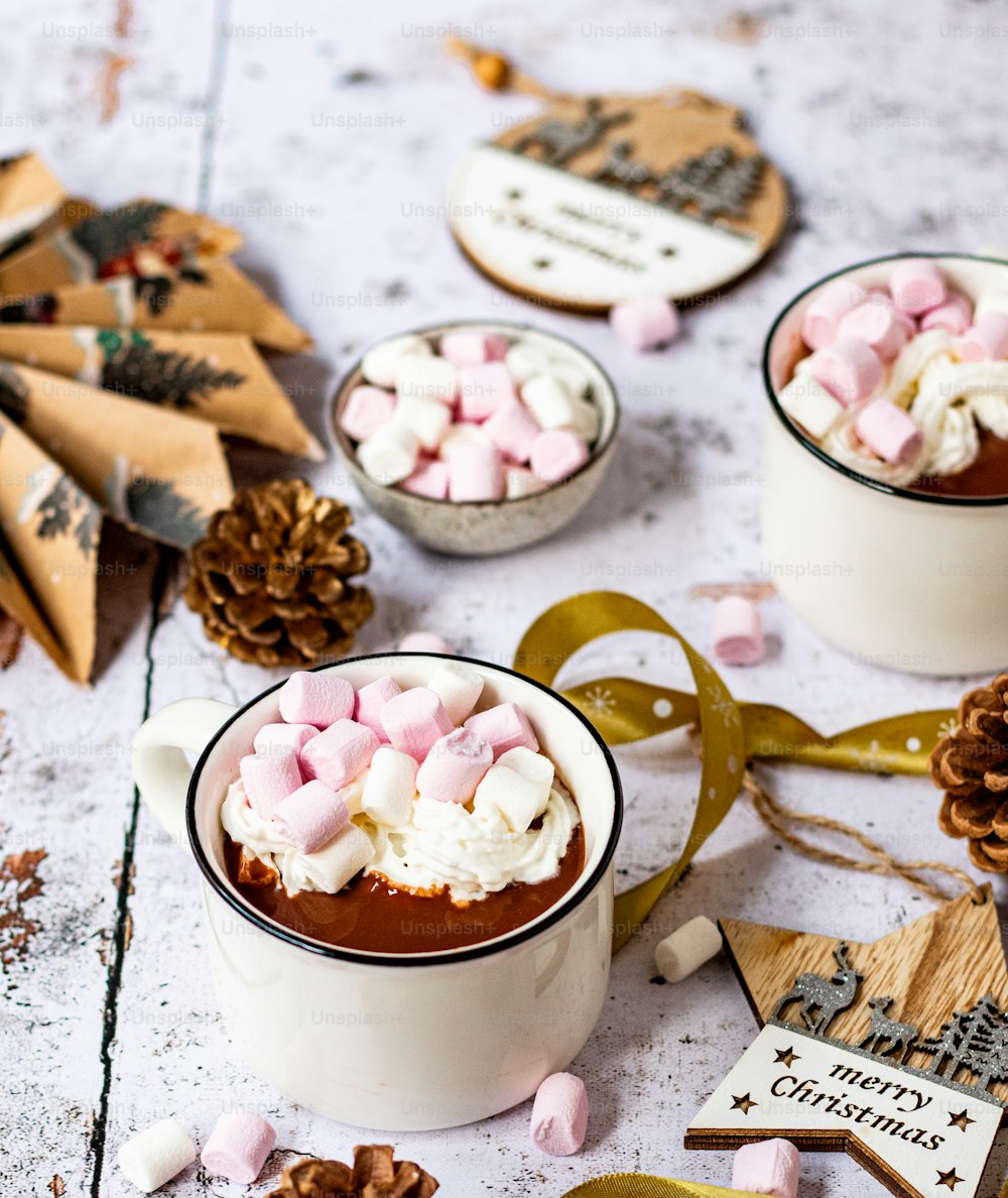 two mugs filled with hot chocolate and marshmallows
